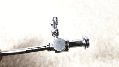 Shiny chrome-plated metal laparoscopic obturator with cylindrical handle and articulated joint for reuse medical use