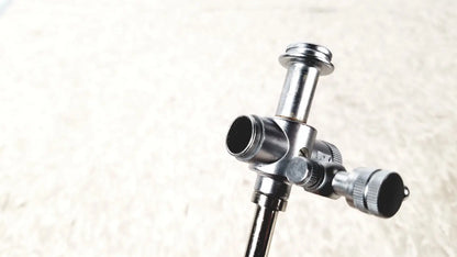 Silver metallic laparoscopic obturator tripod head with central column and adjustable arms for reuse medical laparoscopic instruments