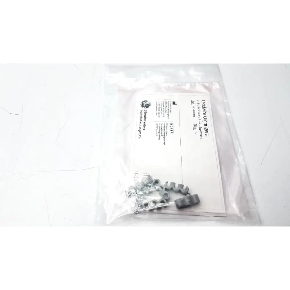 Silver-colored metal leadwire connectors in a clear bag labeled as lead separator ref for leadwire organizer use