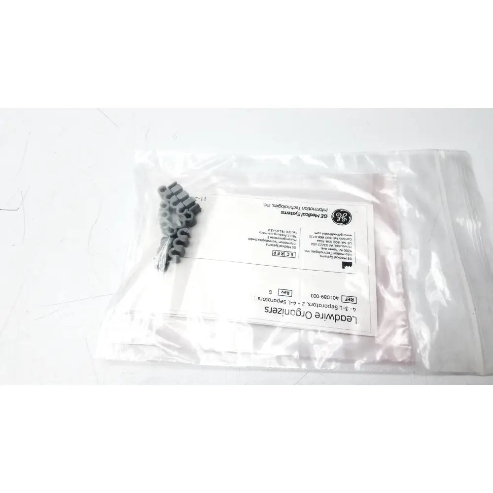 Gray plastic leadwire organizer with lead separator ref 401089-003 in clear bag and printed labeling
