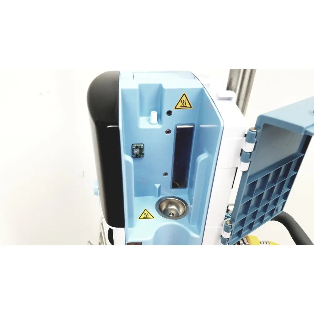 Light blue and black Leica EG1150H embedding center with hinged side panel showing internal components for laboratory use