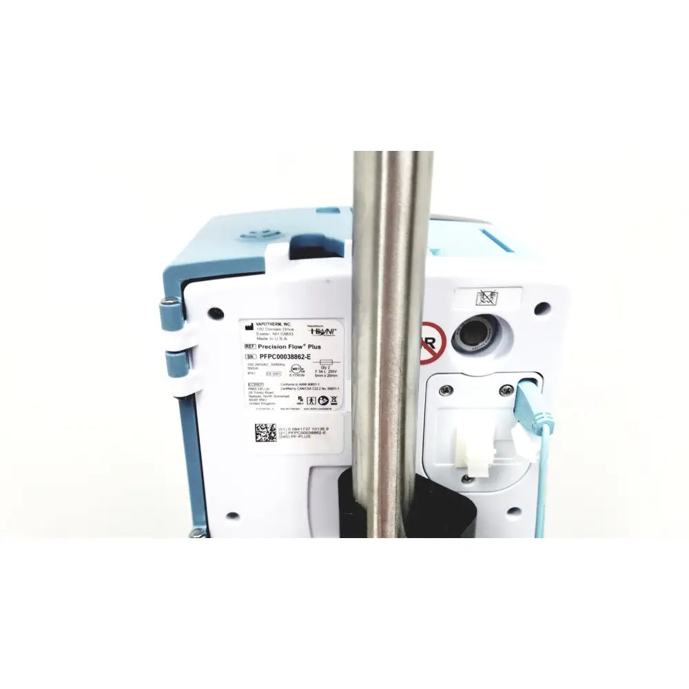 A white and light blue medtronic precision flow plus infusion pump attached to a metallic pole with leica eg1150h embedding center