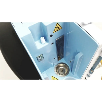 Light blue plastic housing with metallic circular basin and warning labels in leica eg1150h embedding center