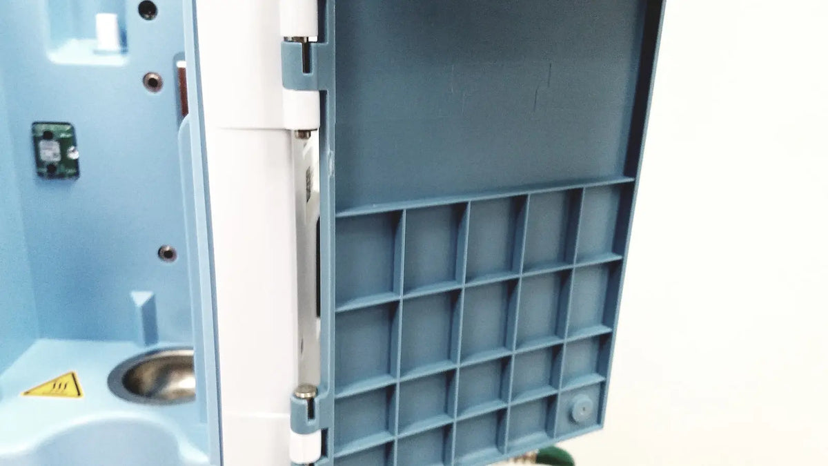 Blue plastic compartmentalized storage tray with white hinge and metallic latch for leica eg1150h embedding center