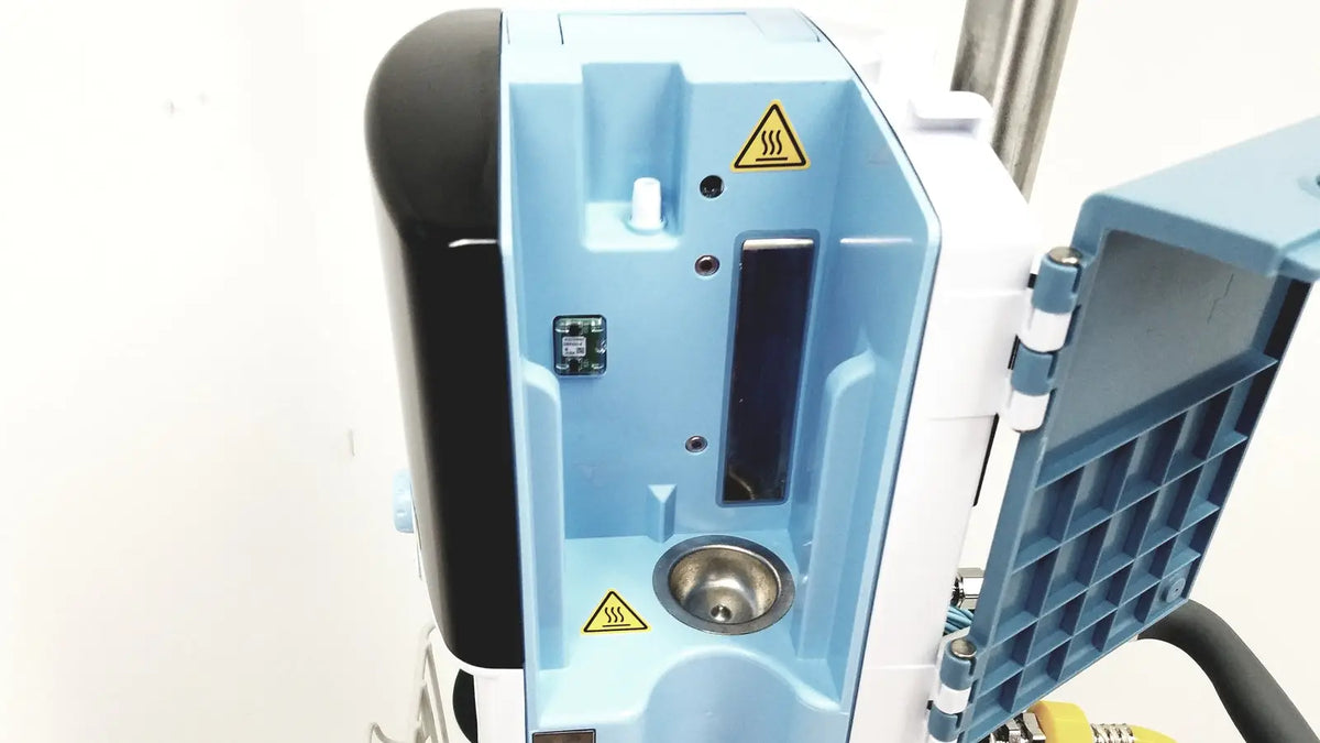Light blue and black Leica EG1150H embedding center with hinged side panel showing internal components for laboratory use