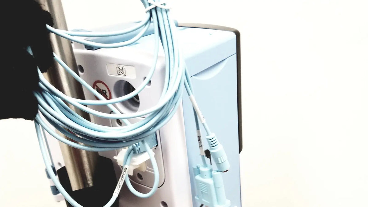 Light blue coiled cables with matching connectors wrapped around the side of a white leica eg1150h embedding center