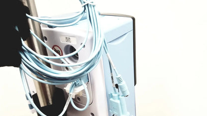 Light blue coiled cables with matching connectors wrapped around the side of a white leica eg1150h embedding center