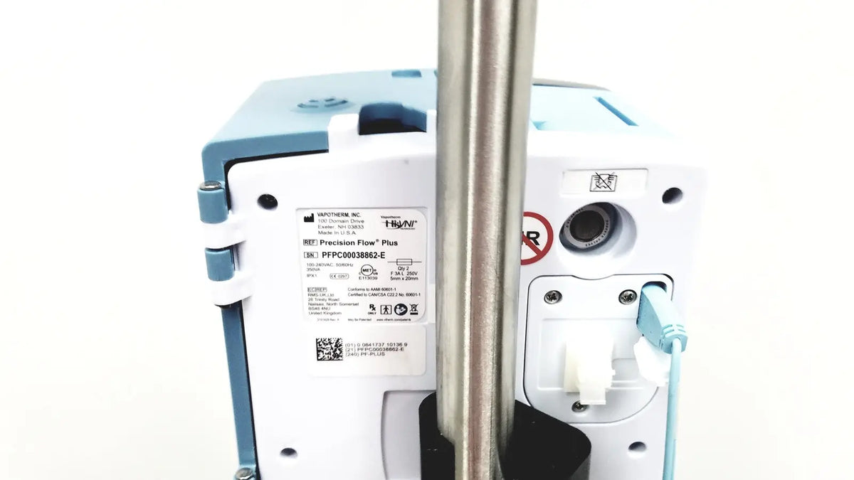 A white and light blue medtronic precision flow plus infusion pump attached to a metallic pole with leica eg1150h embedding center