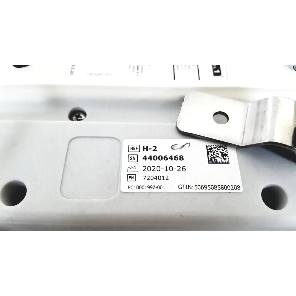 White rectangular label with black text and qr code on metallic surface of model h-2 pressure chambers