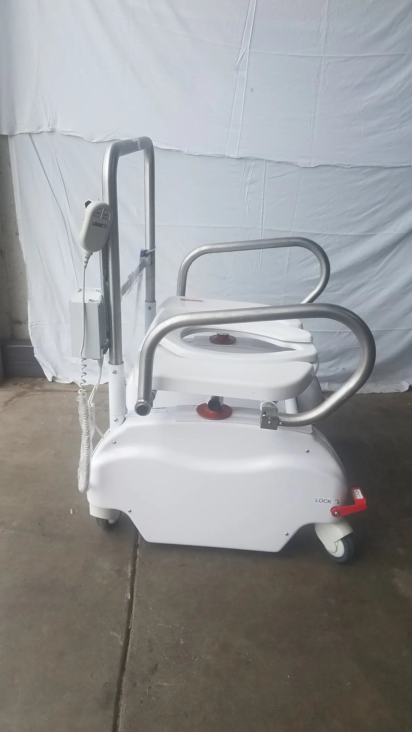 White liftseat ls600 bariatric power toilet lift with silver metal handrails and red emergency stop button