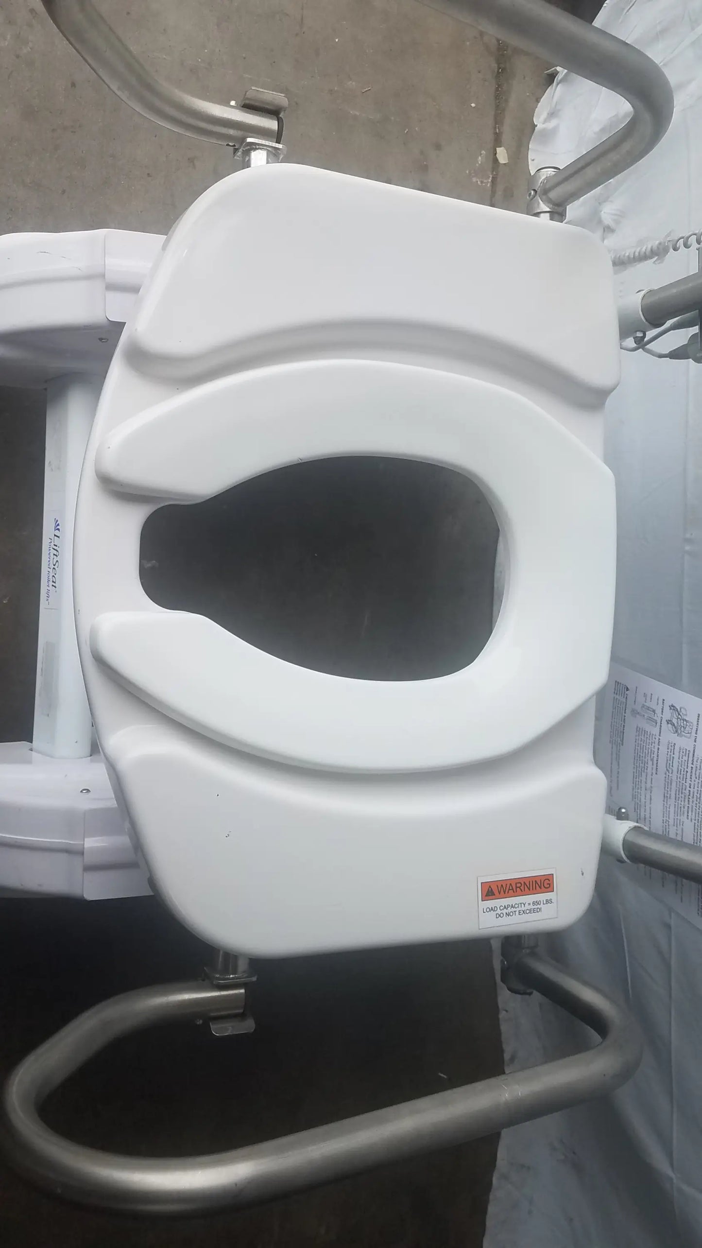 White plastic toilet seat with contoured design and metal support frame for liftseat ls600 bariatric power toilet lift