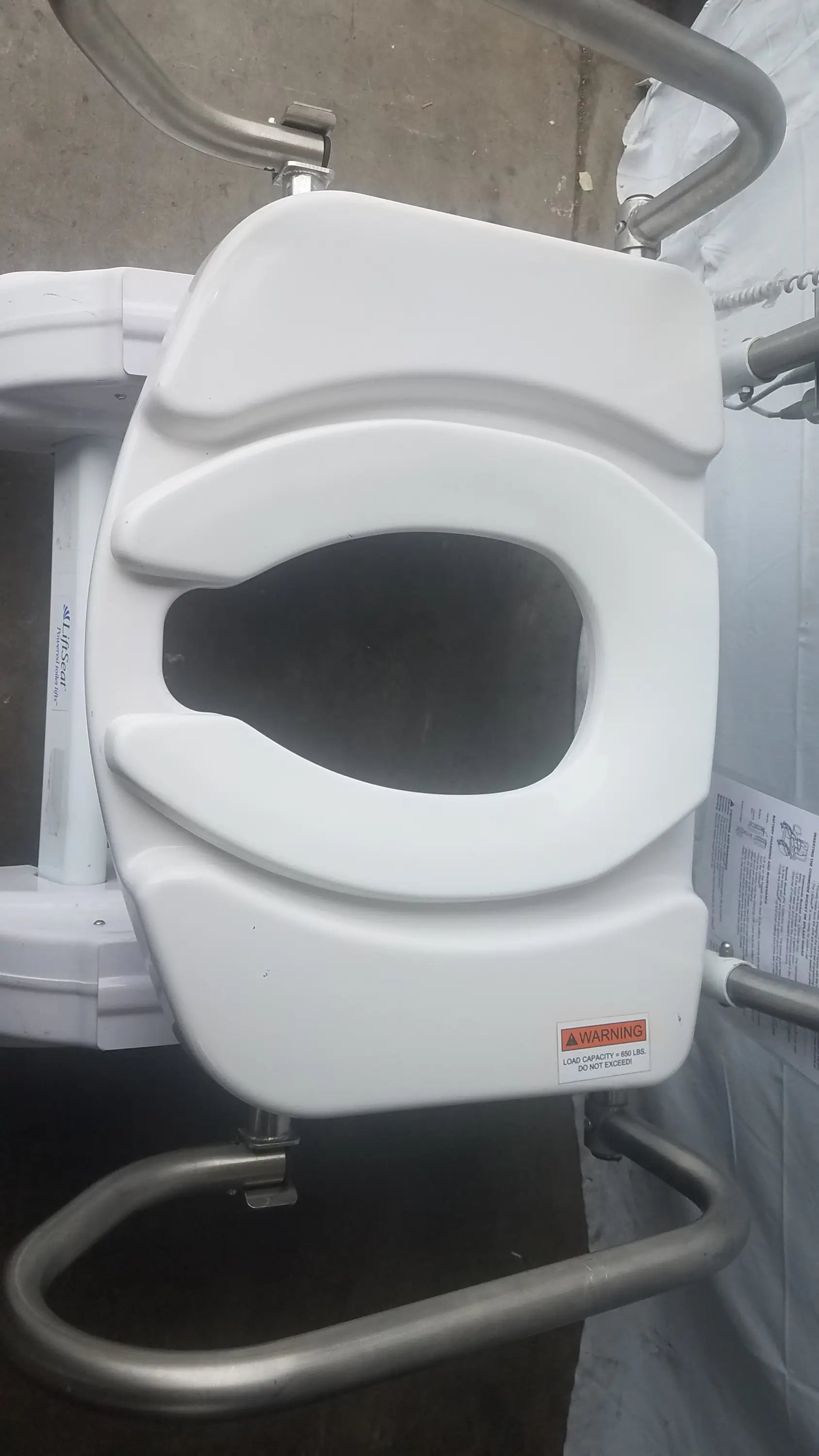White plastic toilet seat with contoured design and metal support frame for liftseat ls600 bariatric power toilet lift