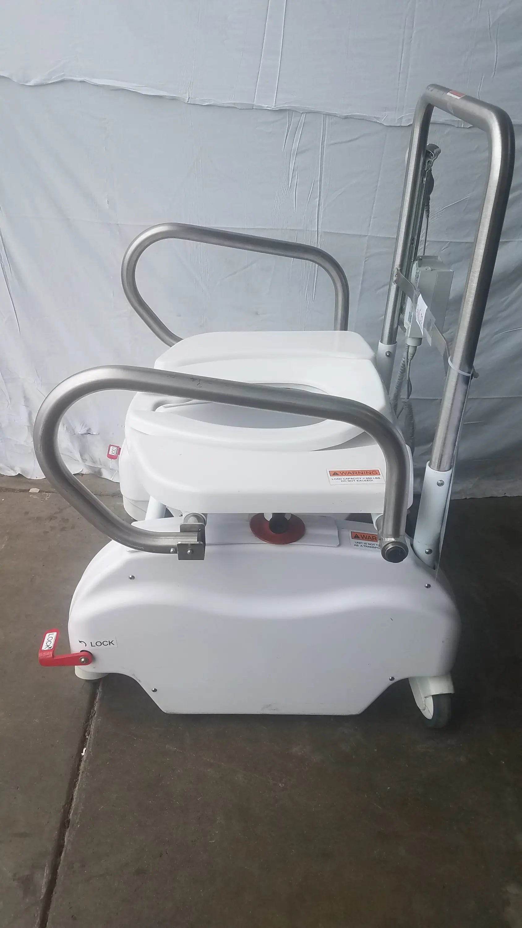 White plastic bariatric power toilet lift with chrome metal frame and handles featuring adjustable seat base