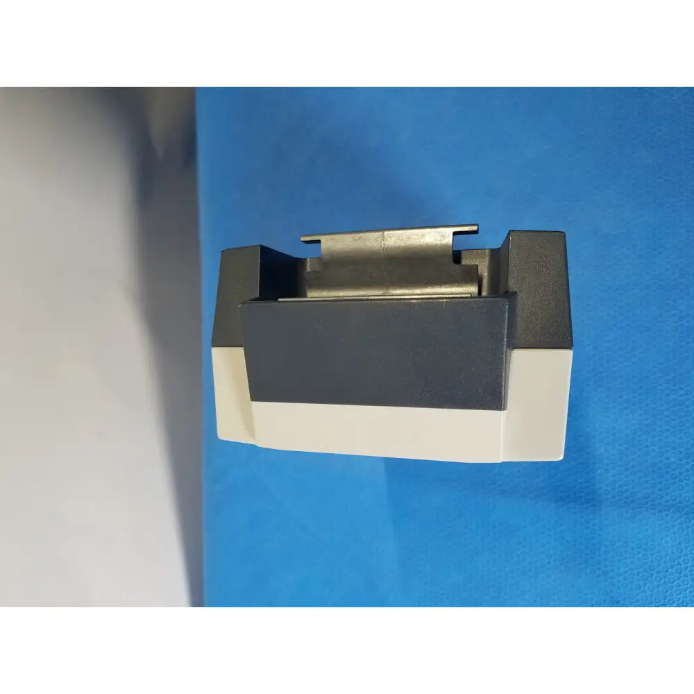 Black and white plastic housing with metallic connector on top of linak baj100000011 24v rechargeable battery