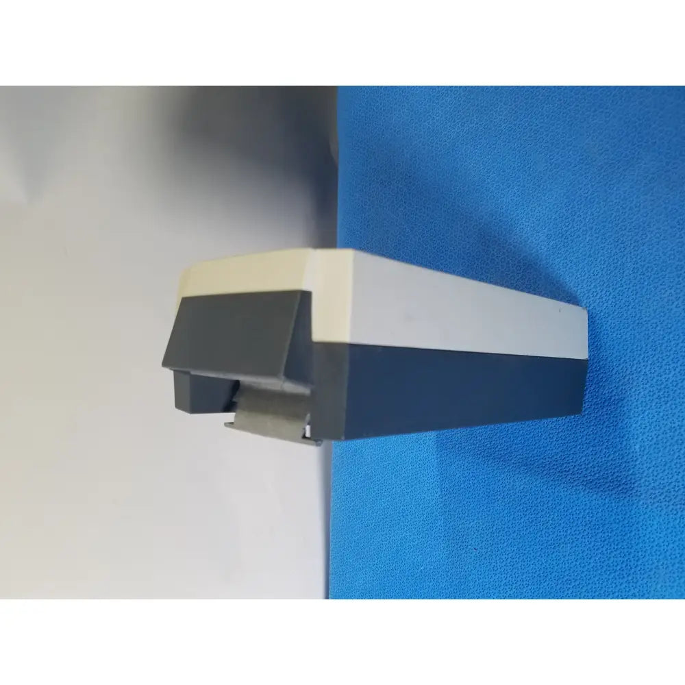 Three-toned beige white and dark gray plastic tape dispenser shown with linak baj100000011 24v rechargeable battery for patient lift hoist