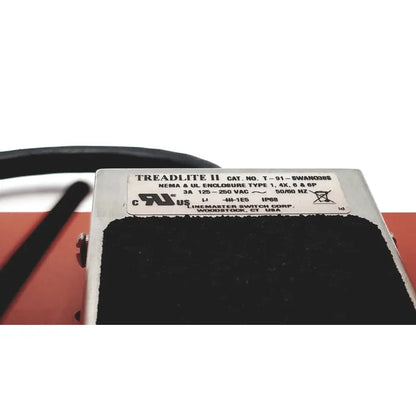 Silver metal linemaster cat treadlite ii foot switch with black rubberized top and white technical label visible