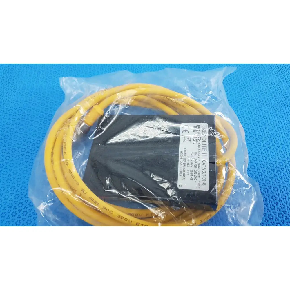 Yellow coiled cable and black power supply unit inside clear packaging for linemaster treadlite t-91-s foot switch