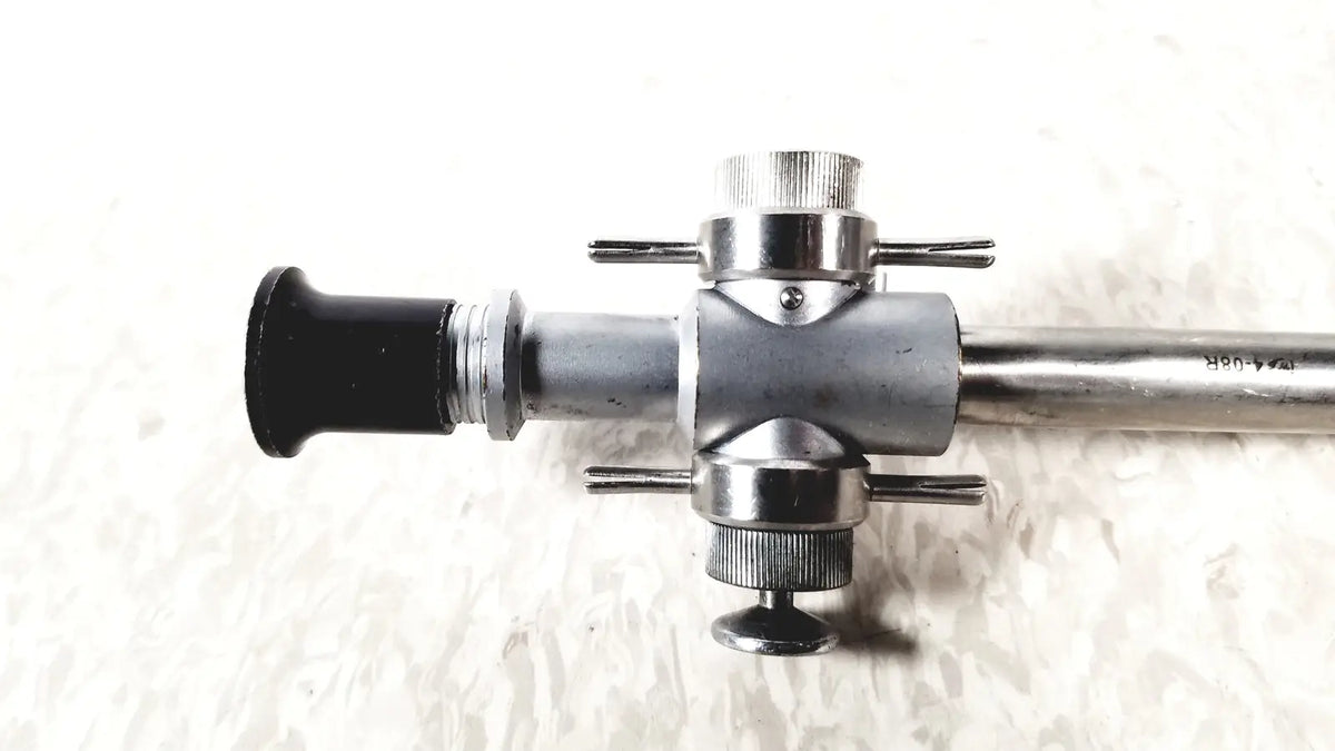 Linvatec 118100 L 354530 silver metallic laparoscopy cannula with black rubberized eyepiece and knurled adjustment knobs