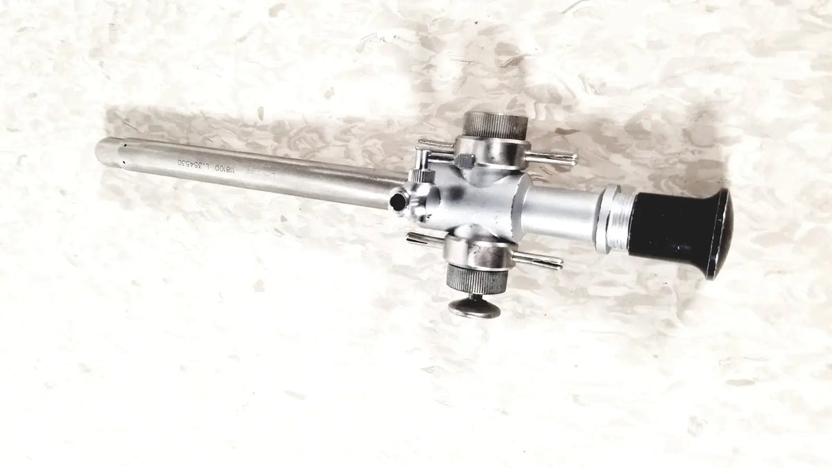 Silver-colored linvatec 118100 l 354530 laparoscopy cannula with black rubber grip and multiple adjustment knobs for reuse medical use