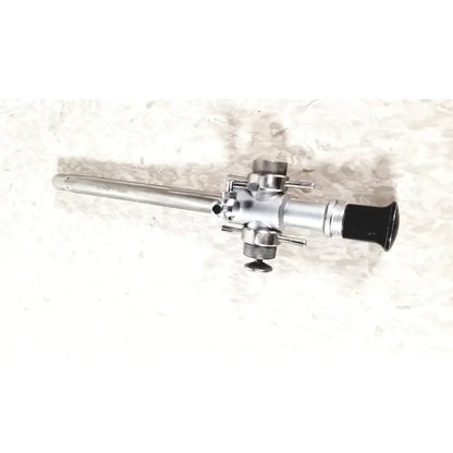 Silver-colored linvatec 118100 l 354530 laparoscopy cannula with black rubber grip and multiple adjustment knobs for reuse medical use