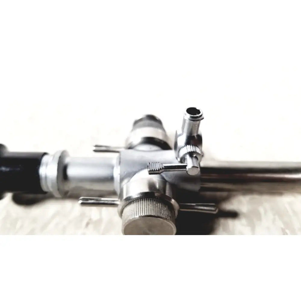 Silver metallic Linvatec 118100 L 354530 laparoscopy cannula with black tubing and textured knobs for reuse medical use