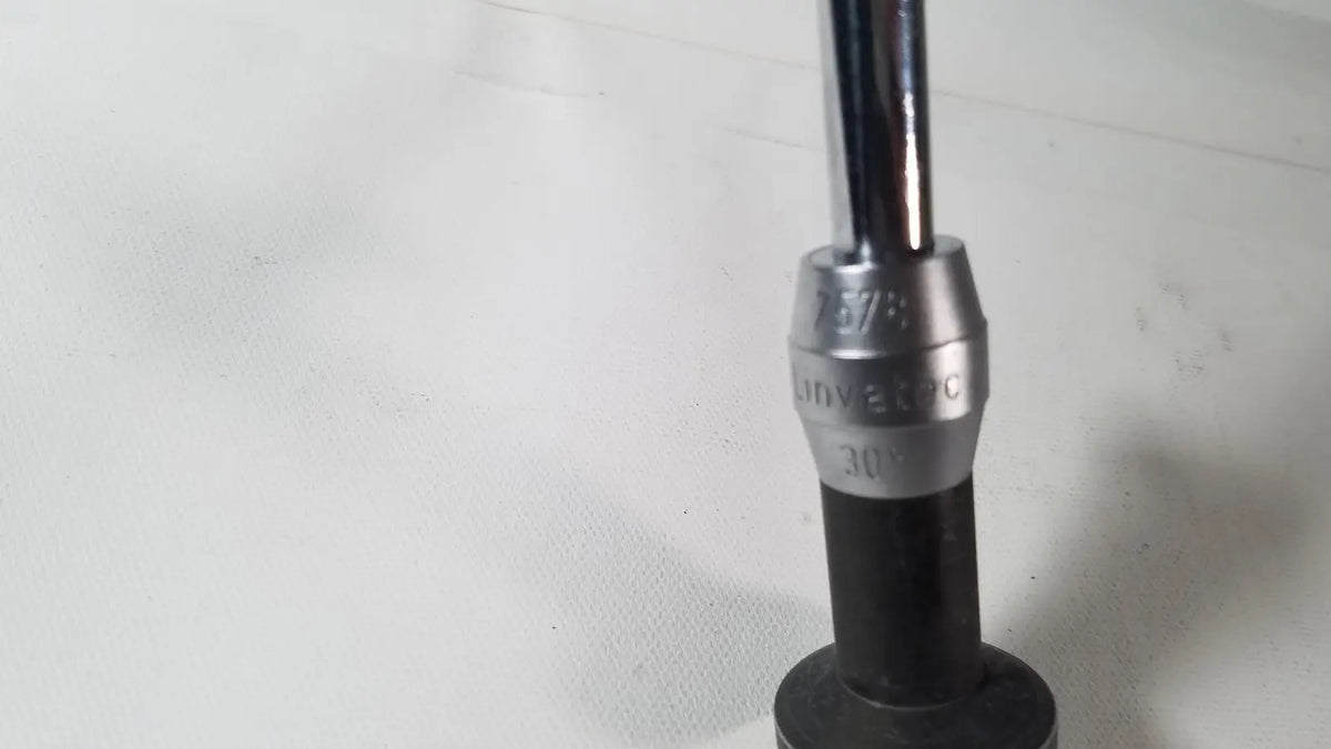 Silver and black universal socket wrench with 30-degree angled tip for use with linvatec degree laparoscope a1261
