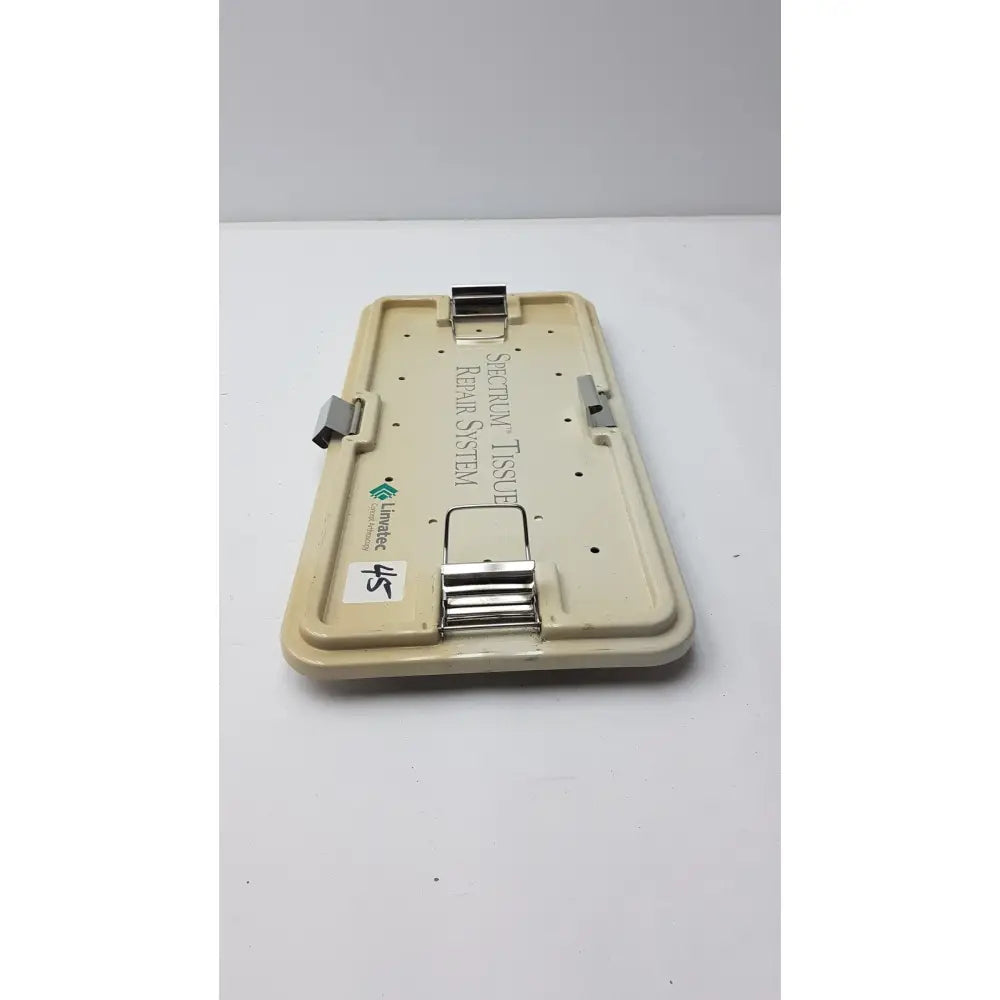 Beige plastic surgical tissue retraction system with metal clamps labeled spectraflow in linvatec concept arthroscopy spectrum tray
