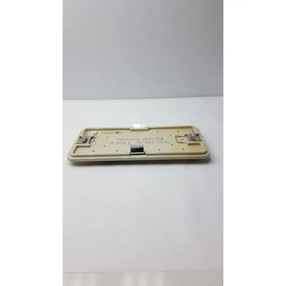 Beige plastic linvatec concept arthroscopy spectrum tissue repair system tray with metallic clamps and central slot