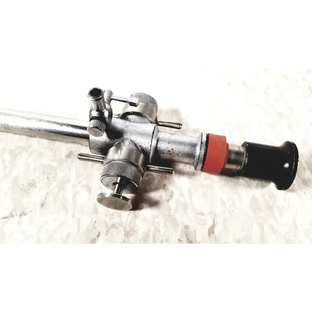 Silver metallic linvatec conmed 118100 hasson laparoscopic valve with black handle and red accent ring surgical instrument