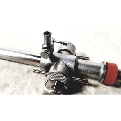 Industrial-grade metal gas torch with red rubberized grip and adjustment knobs for linvatec conmed hasson laparoscopic valve