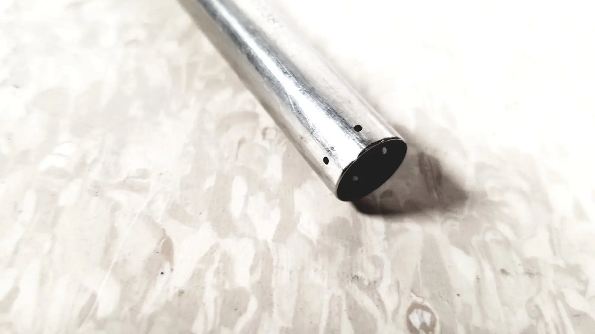 Silver metal hasson laparoscopic valve pipe with black-painted end and three holes linvatec conmed 118100 back side