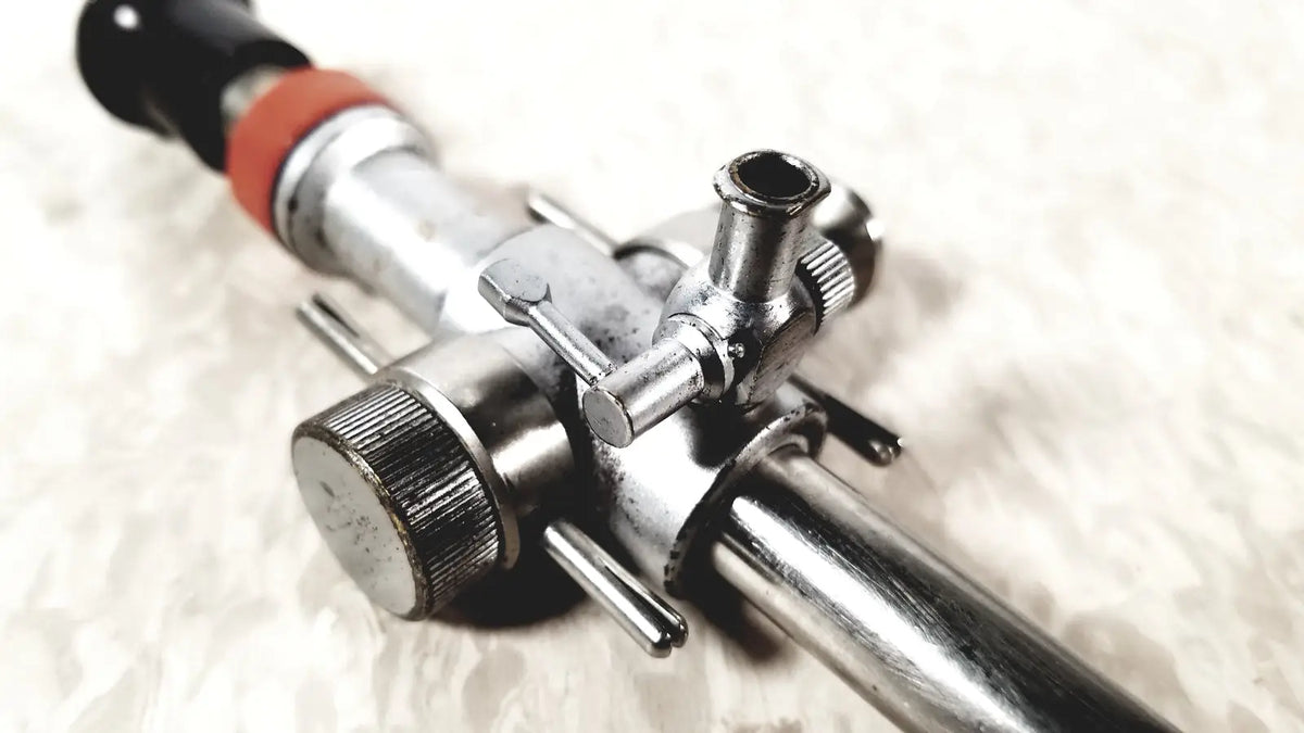 Silver metallic linvatec conmed 118100 hasson laparoscopic valve gas regulator with black and orange accents