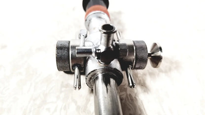 Silver metallic linvatec conmed hasson laparoscopic valve with textured knobs and black-tipped handle for surgery