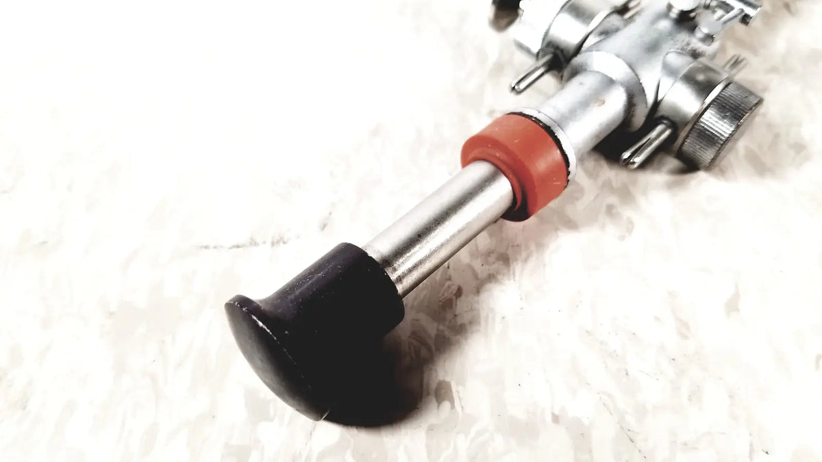 Silver metal bicycle pedal with black rubber grip and red plastic collar for linvatec conmed hasson laparoscopic valve