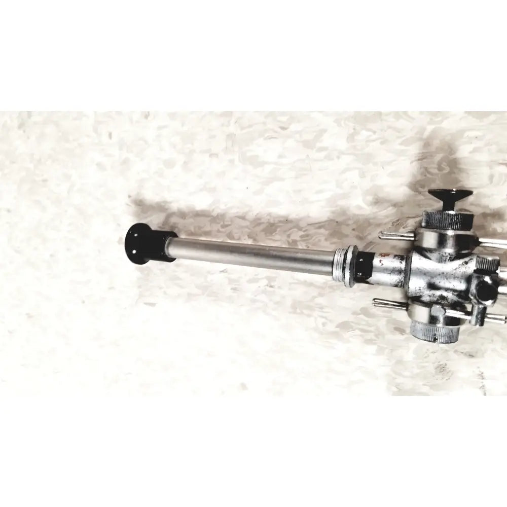 Silver metallic linvatec conmed 118100 laparoscopic valve with black caps and threaded fittings for laparoscopic instruments