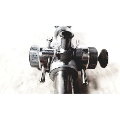 Metallic linvatec conmed 118100 laparoscopic valve with textured knobs and central pipe for reuse medical applications