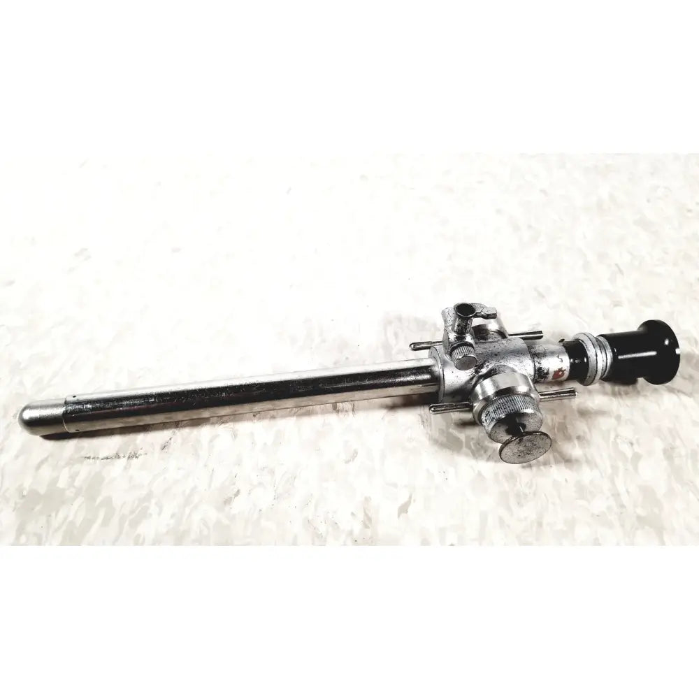 Silver linvatec conmed laparoscopic valve endoscope with black lens cap and metallic adjustment knobs for reuse medical use