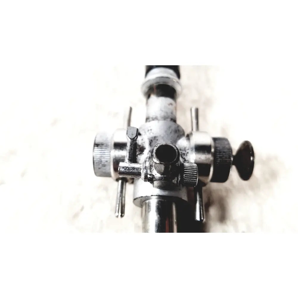 A weathered metallic linvatec conmed 118100 laparoscopic valve with multiple knobs and adjustment levers for laparoscopic instruments
