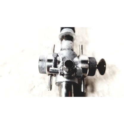 A weathered metallic linvatec conmed 118100 laparoscopic valve with multiple knobs and adjustment levers for laparoscopic instruments