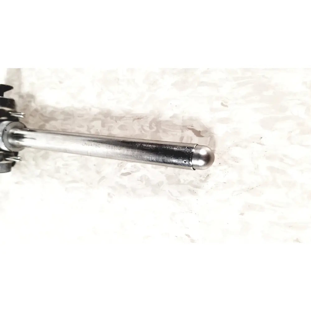 Silver metallic cylindrical laparoscopic valve with rounded end and engraved linvatec conmed model number 118100