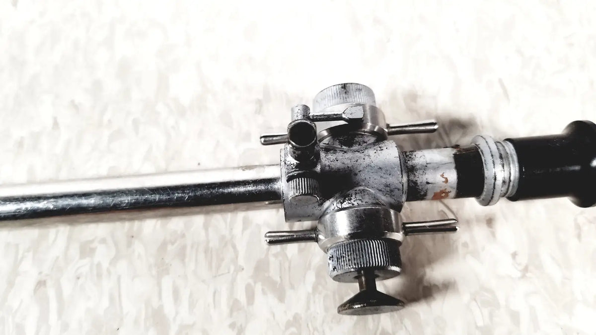 Silver and black linvatec conmed 118100 laparoscopic valve with adjustable knobs and connectors for laparoscopic instruments