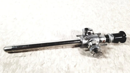 Silver linvatec conmed laparoscopic valve endoscope with black lens cap and metallic adjustment knobs for reuse medical use