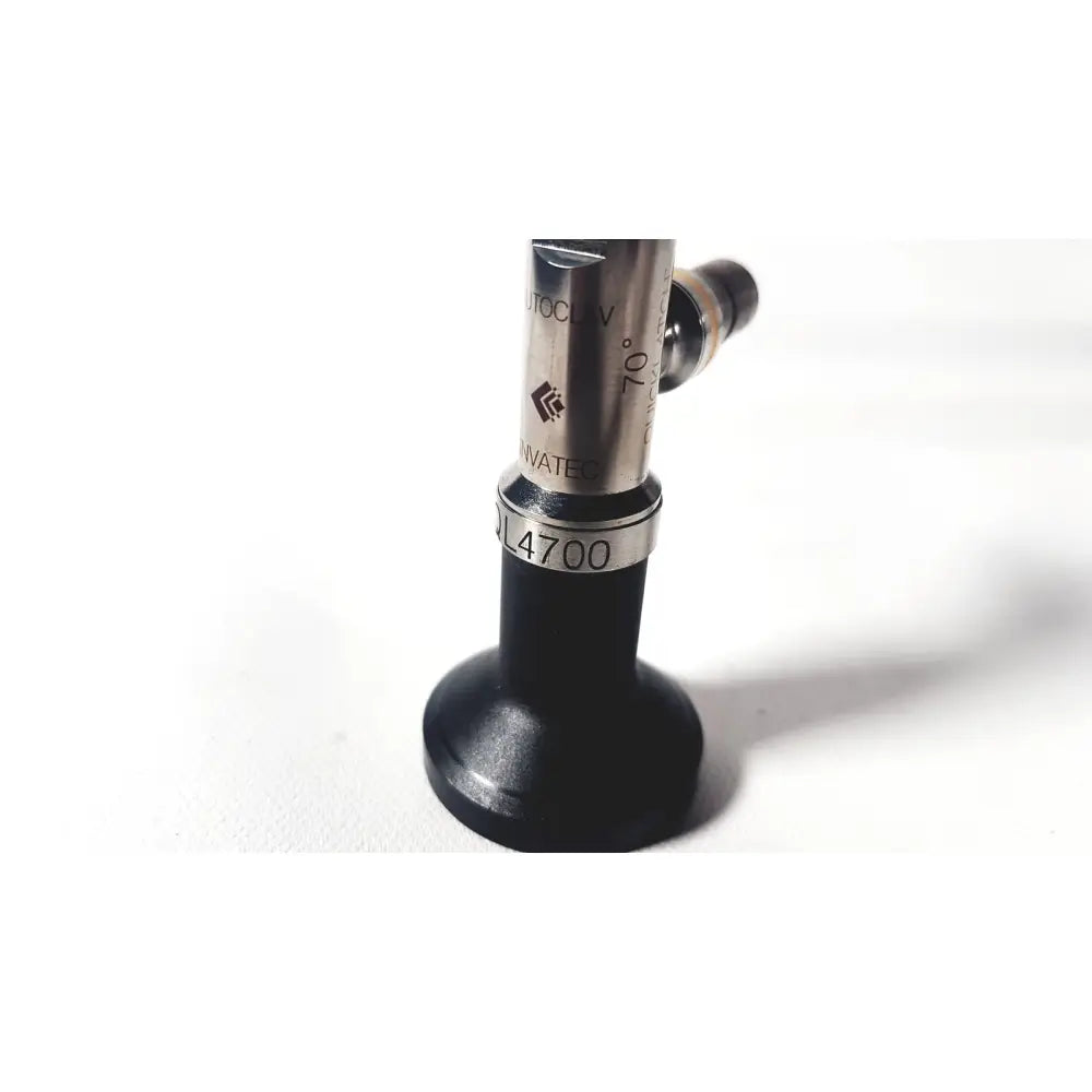 Silver and black linvatec ql4700 quicklatch 4mm arthroscope arthroscopy with engraved markings and cylindrical metallic body