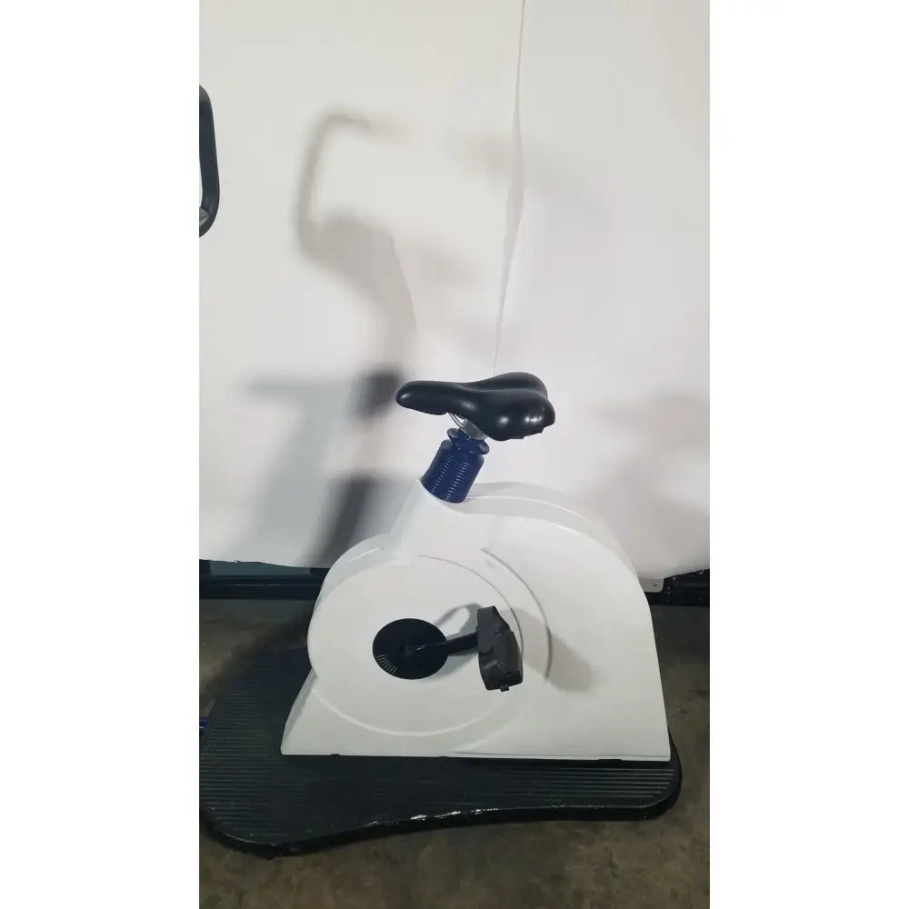 White stationary ergometer stress test bike with black seat pedals and handlebars for test ecg ekg diagnostics