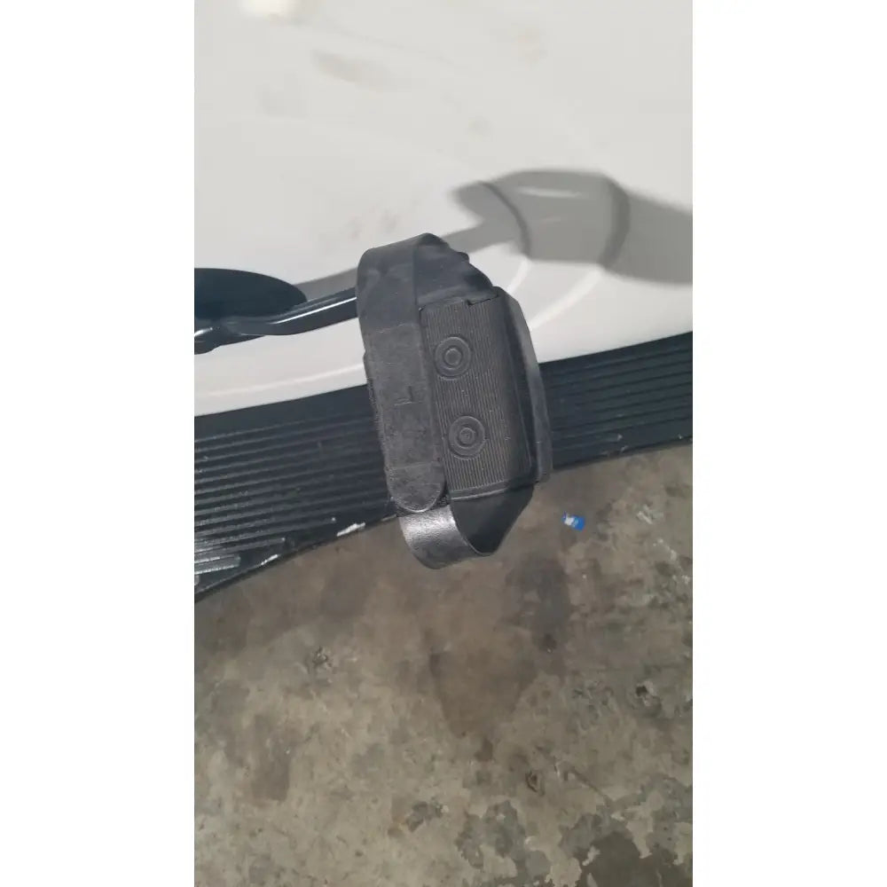Black plastic textured seat belt buckle with circular indentations for lode corival 912900 ergometer stress test ecg use
