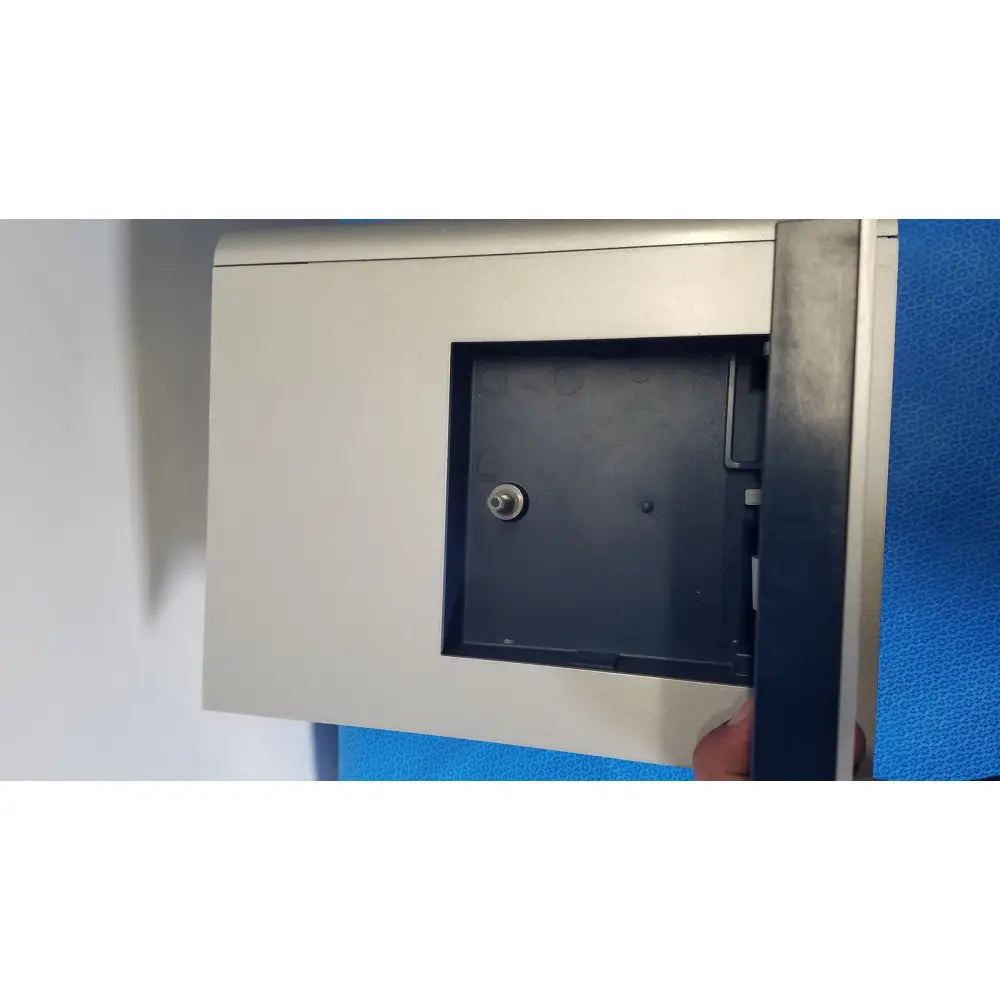 Silver metallic wall-mounted key safe with black interior and central locking mechanism for core unit transfection use