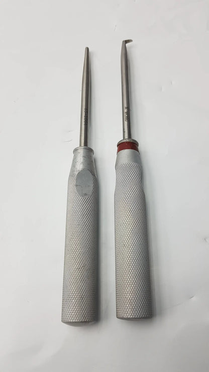 Lot of 2 codman 8710n osteophyte metallic orthopedic surgical elevators with textured silver handles and red accents