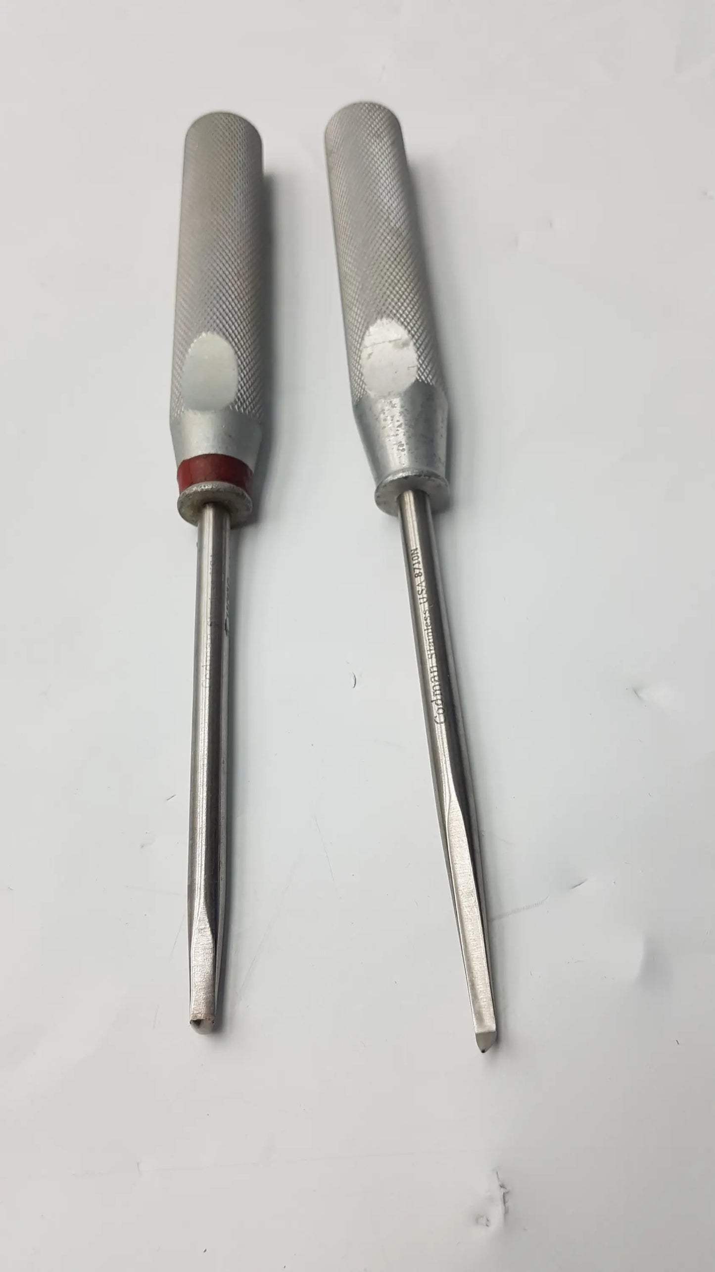 Lot of 2 codman 8710n osteophyte elevators with textured silver handles and red bands for orthopedic surgical use