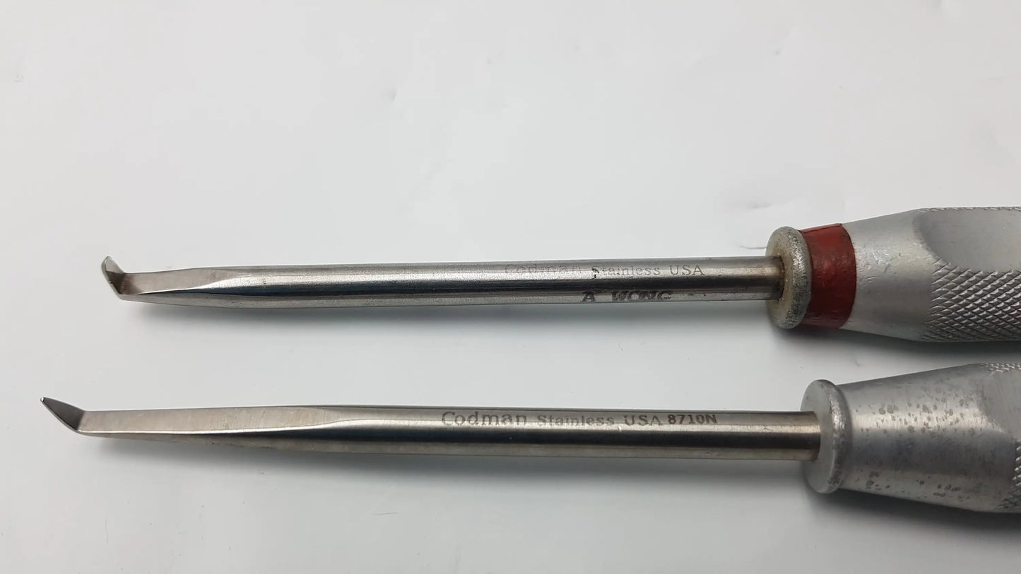 Two stainless steel codman 8710n osteophyte elevators with textured silver handles and red accents for orthopedic surgical use