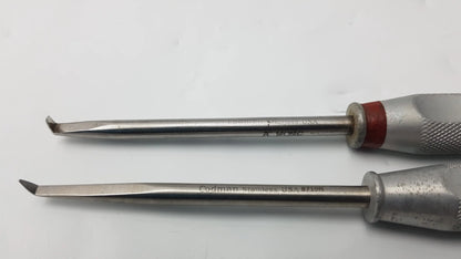 Two stainless steel codman 8710n osteophyte elevators with textured silver handles and red accents for orthopedic surgical use
